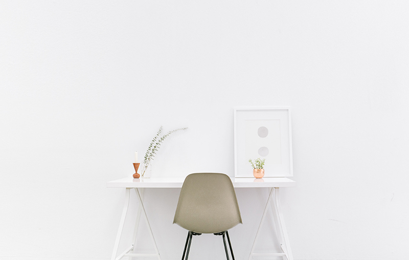 chair and desk with vases and picture frame